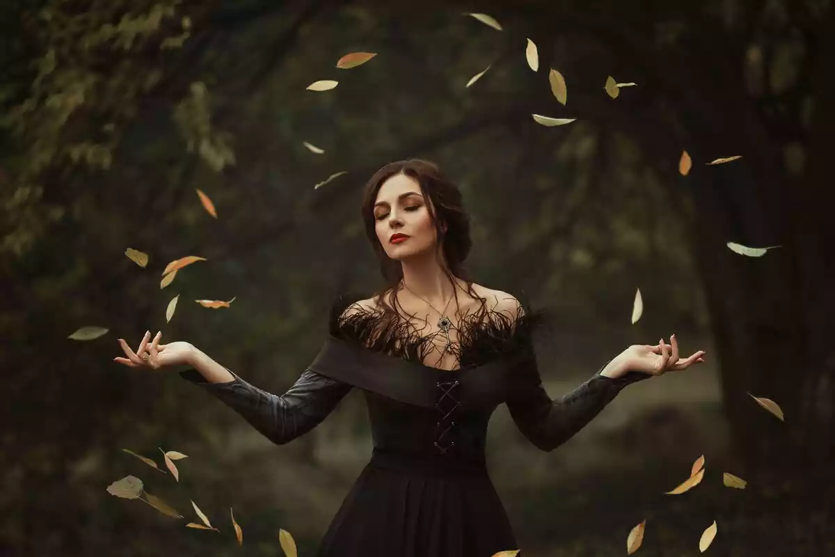 Witch doing magic with leaves