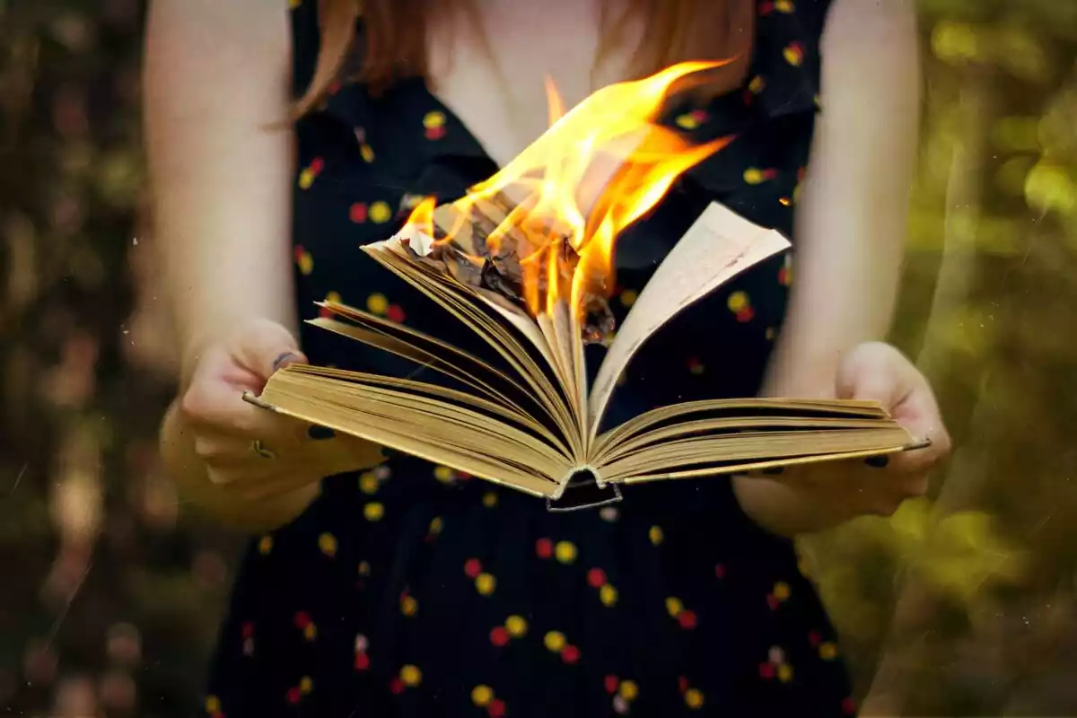 Woman holding a burning book
